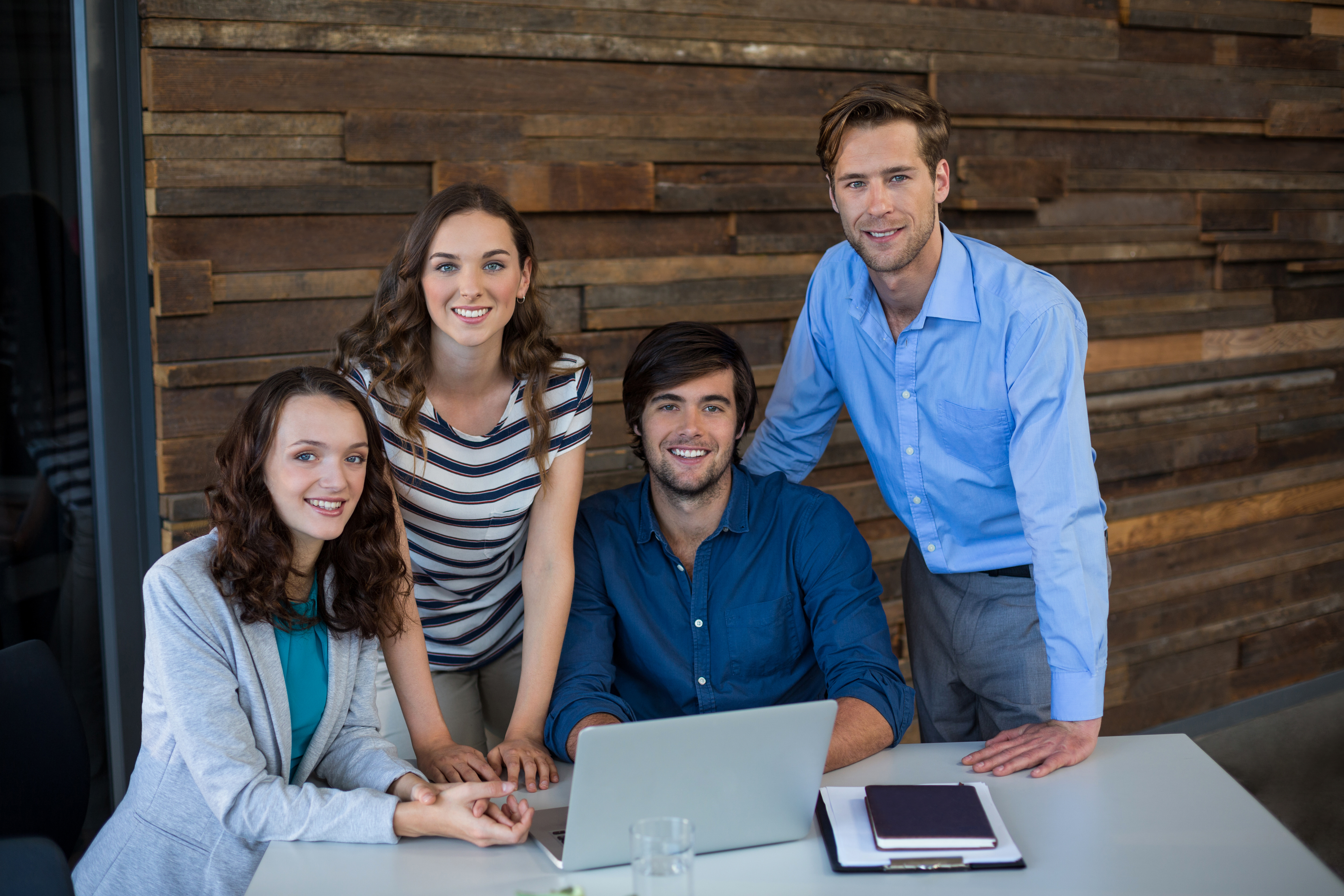 Digital marketing team working on laptop with analytics dashboard